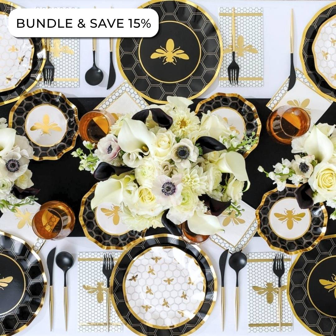 The Sophistiplate Rosh Tablescape for 16 Guests: Honeybee features an elegant bee-themed Rosh Hashanah table setting with black, gold, and white designer disposable plates, floral centerpieces, amber glasses, and gold utensils arranged neatly; a “Bundle & Save 15%” offer is displayed at the top left corner.