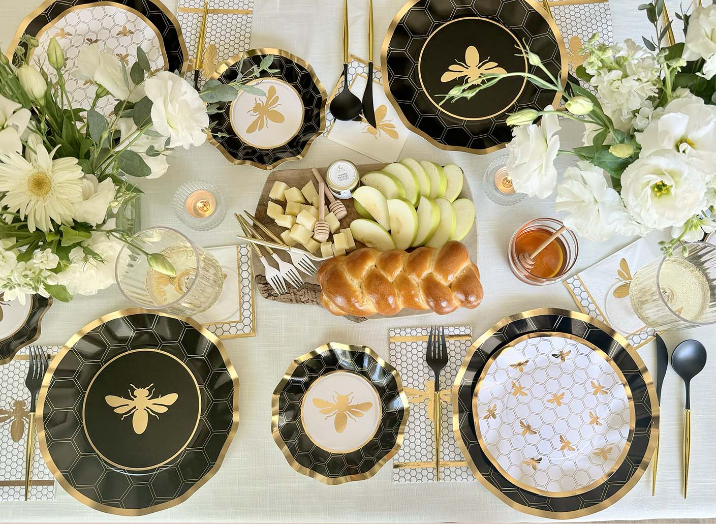a beautiful rosh hashanah table with honeybee plates