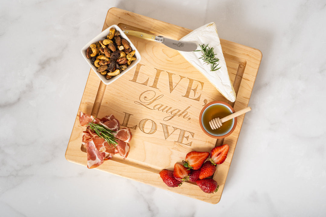 wooden board with meat and cheese