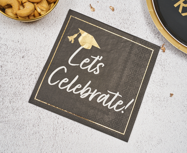 Sophistiplate’s Classic Grad Cocktail Napkins (26pk) feature a black design with gold trim, a gold cap, and "Lets Celebrate!" in white script—perfect for adding stylish flair to your graduation celebration table setting.