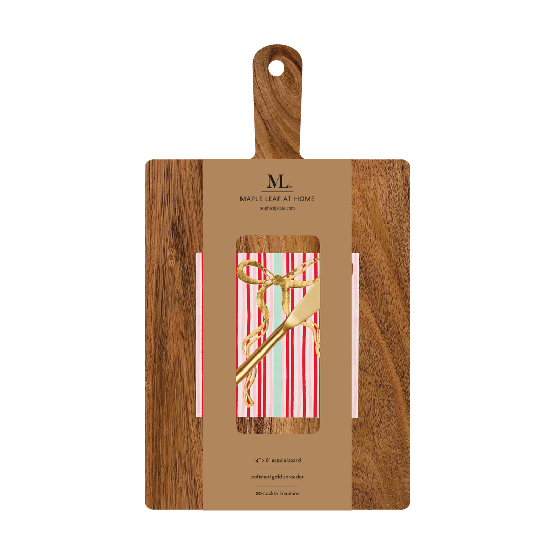 A 14″ x 8″ Board Gift Kit w/ Gold Spreader: Tis the Season consisting of an acacia wood charcuterie board, a gold spreader, and a pack of striped cocktail napkins with a gold ribbon print, secured by a branded cardboard sleeve.