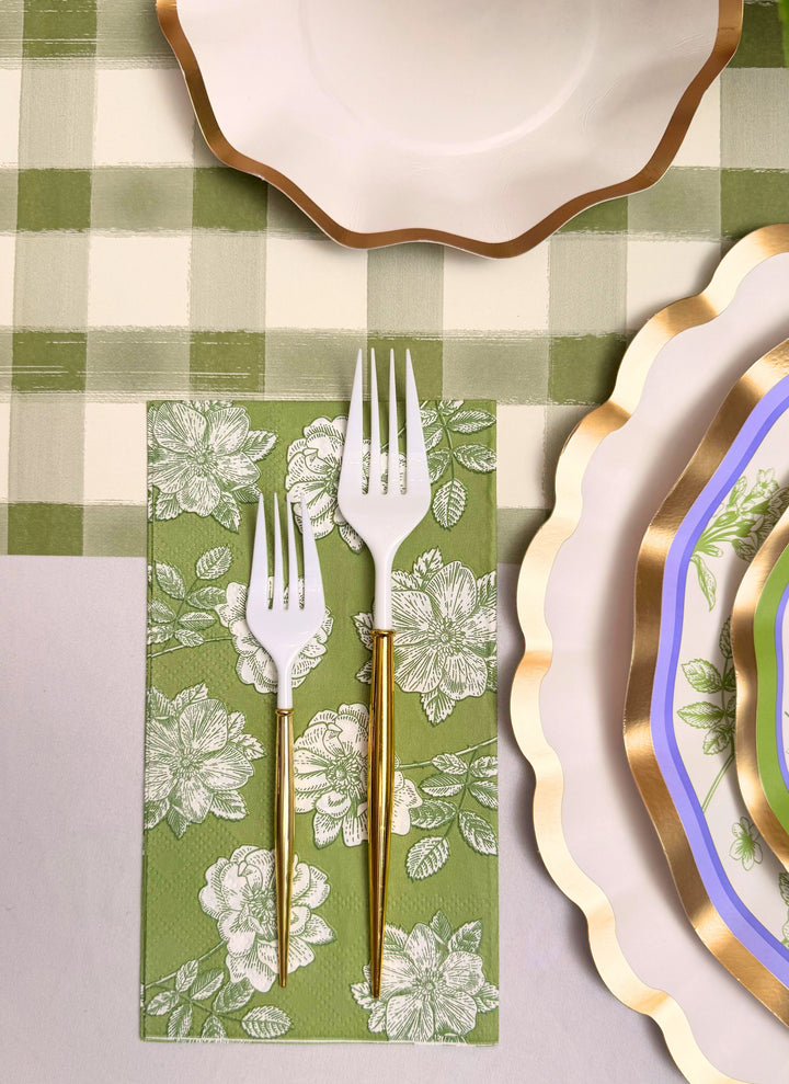 The Ultimate Easter Tablescape for 16: Easter Toile by Sophistiplate LLC features gold and white forks on a green floral napkin, plus designer paper plates with gold and blue rims atop a green checkered tablecloth—ideal for an elegant Easter.