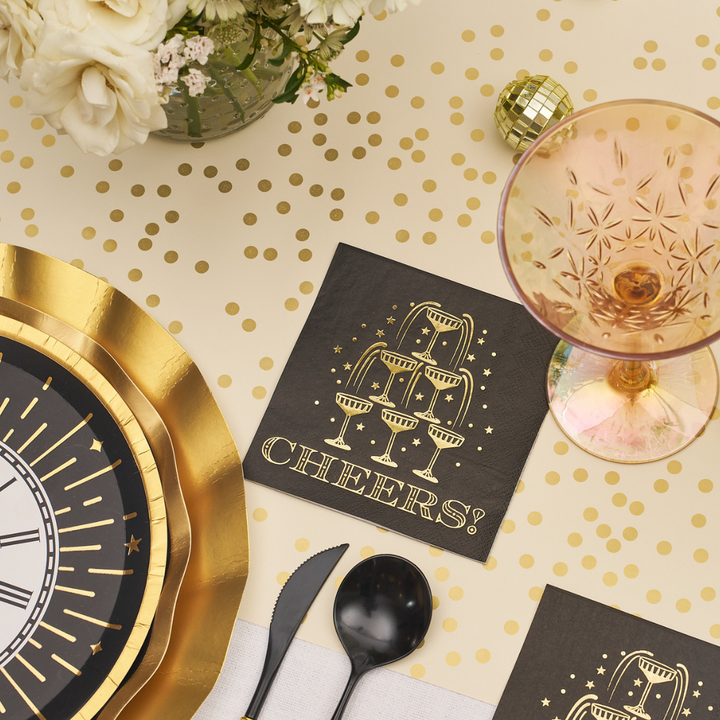 Midnight Sparkle Paper Cocktail Napkin Cheers/26pk black paper cocktail napkins for a New Year’s Eve party, featuring a gold foil illustration of a champagne tower and the text CHEERS!.