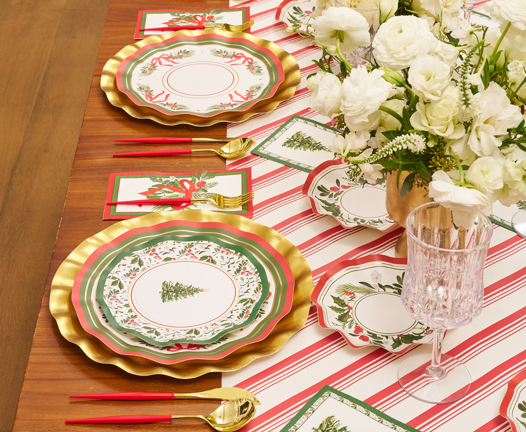 Set a festive table with Sophistiplate’s “Home for the Holidays” Salad Plates (8-pack), featuring gold-rimmed edges and cheerful seasonal designs. Pair them with red and gold cutlery, a vase of white flowers, a striped table runner, and matching napkins to create an elegant and joyful Christmas theme.