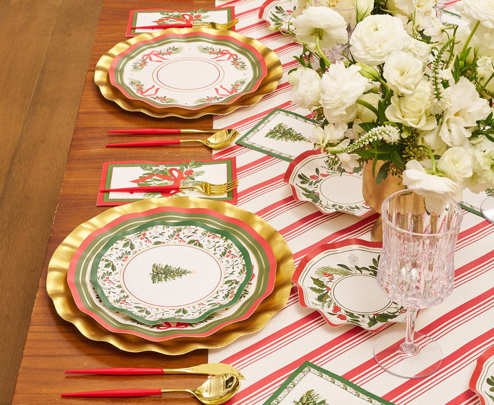 Set a festive table with Sophistiplate’s “Home for the Holidays” Salad Plates (8-pack), featuring gold-rimmed edges and cheerful seasonal designs. Pair them with red and gold cutlery, a vase of white flowers, a striped table runner, and matching napkins to create an elegant and joyful Christmas theme.
