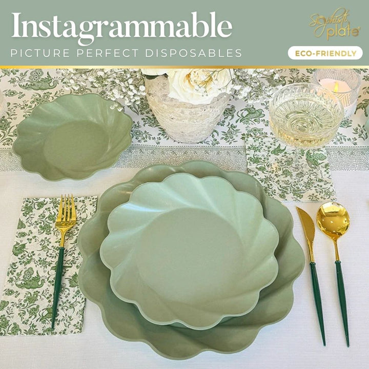 The Eco-friendly Table Setting- Sage by Sophistiplate LLC features stylish green plates, gold and green cutlery, a floral napkin, and a white flower centerpiece for an elegant, sustainable dining experience.