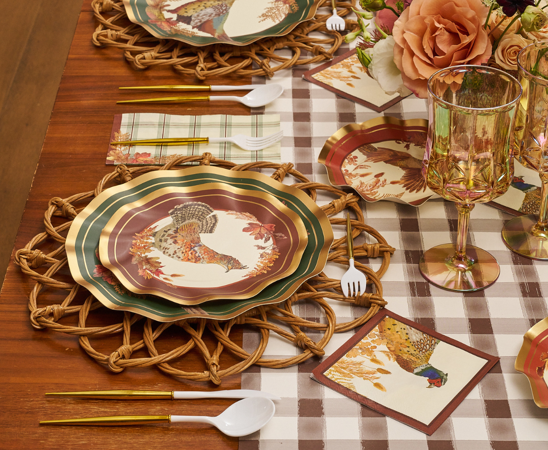 Sure! Here’s the rewritten sentence using the given product data: A fall-themed table setting featuring Sophistiplate Woodland Harvest Salad Plates (8-pack) with turkey patterns, gold utensils, wicker placemats, plaid napkins, glass goblets, and floral centerpieces atop a checkered table runner.
