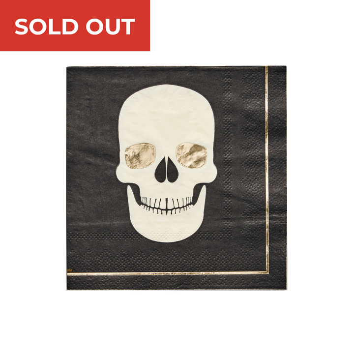 Introducing the Classic Spooky Paper Cocktail Napkin A/20pk by Sophistiplate—a black napkin adorned with a white skull illustration and striking gold foil details, ideal for enhancing your Halloween cocktail napkins collection. A bold red SOLD OUT banner is displayed in the top left corner, marking these limited-edition skull napkins from Sophistiplate as an essential addition for any themed celebration.