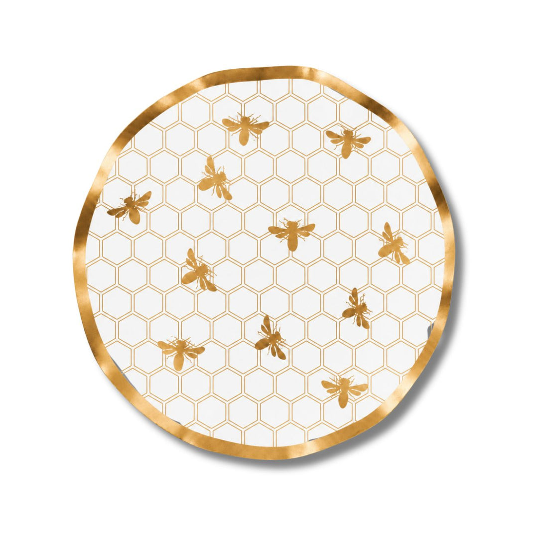 The Sophistiplate Honeybee Wavy Paper Salad Plate (8pk) features a charming honeycomb pattern with gold bees on a crisp white background, elegantly bordered by a gold rim and finished with a delicate ruffled edge, making it the perfect choice to showcase an enchanting honeybee design at your next gathering.
