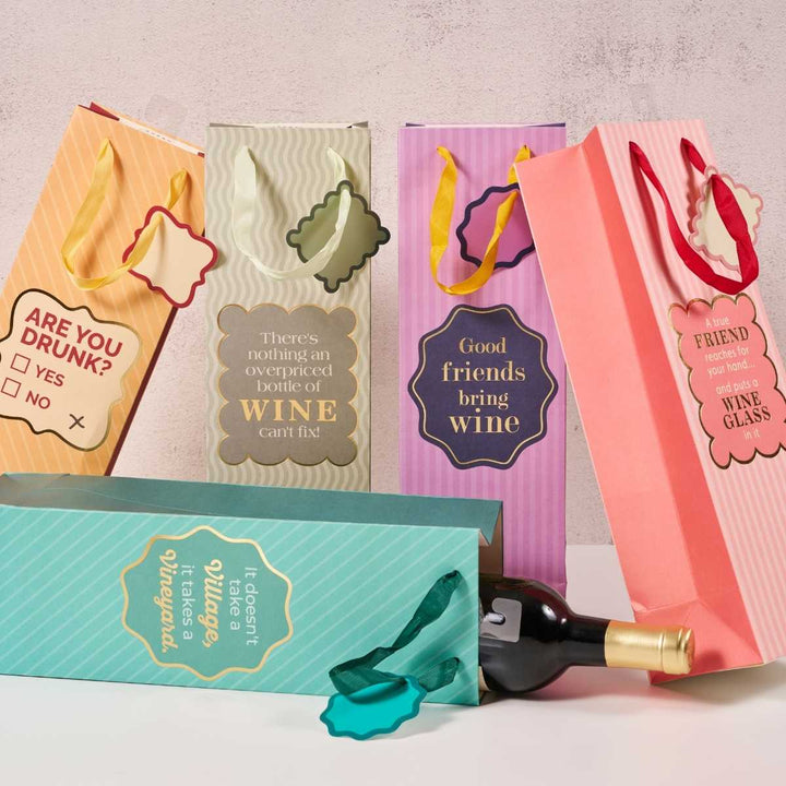 The Drinks On Me Good Friends Wine Bag set includes five upright, colorful reusable bags with witty sayings about wine and friendship, plus one bag with a bottle inside. Ribbon handles make these the perfect hostess gift.