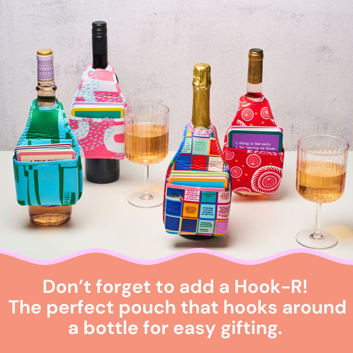 Three bottles of wine with vibrant Hook-R pouches and glasses are shown on a table. Text below: Add a Hook-R! The perfect pouch for your bottle—great for Sophistiplate LLC’s Cheers to Mom Gift Set 1 or as a fun Mother's Day gift.