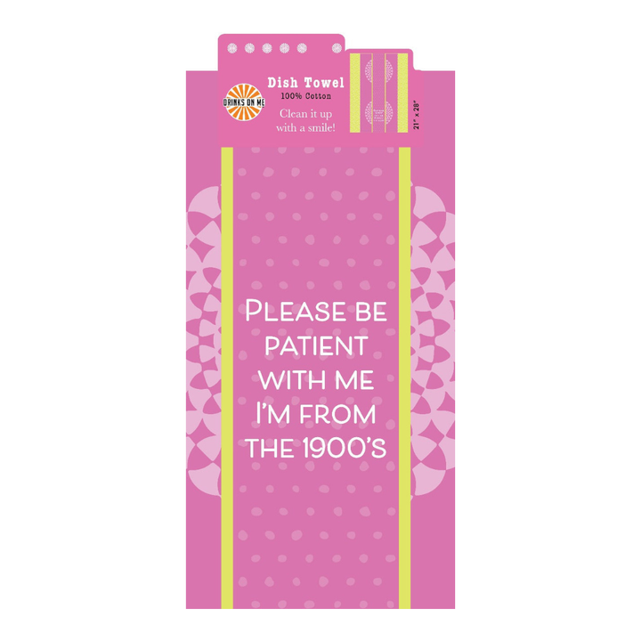 The Drinks On Me 1900's Towel is a pink cotton dish towel with playful patterns and the text: "Please be patient with me, I'm from the 1900s." A funny and charming housewarming gift for any kitchen.