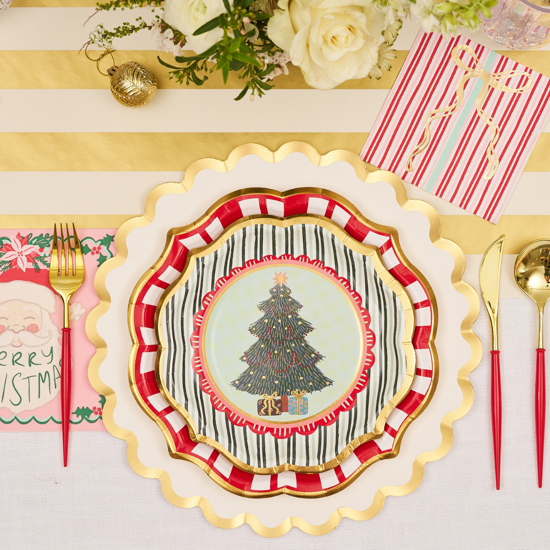 Create a festive table setting with Sophistiplate’s Tis the Season Salad Plates (pack of 8), each layered to showcase their charming Christmas tree design. Pair them with gold-striped placemats, gold utensils, and holiday-themed napkins for a joyful holiday look. Complete the scene with white flowers and sparkling gold ornaments as elegant accents.