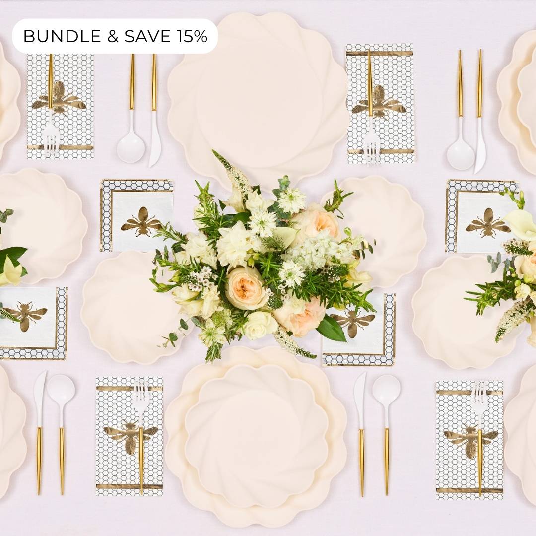 Elevate your Rosh Hashanah celebration with the Sophistiplate LLC “Rosh Tablescape for 16 Guests: Eco Cream Honeybee”—an elegant table setting that includes cream scalloped disposable party plates, gold cutlery, and floral napkins with dragonfly designs, all beautifully arranged around a centerpiece of white and peach flowers. A “Bundle & Save 15%” label is displayed in the top left corner.