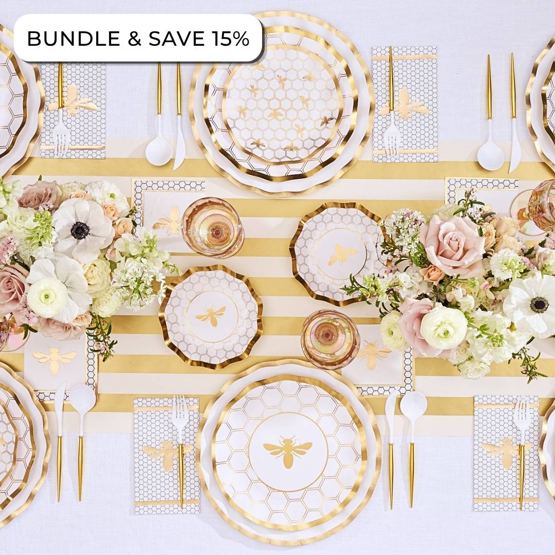 Create an elegant table setting with the Sophistiplate LLC Rosh Tablescape for 16 Guests: White Honeybee, featuring gold bee-themed Rosh Hashanah tableware, a striped table runner, floral arrangements, designer paper plates, coordinating paper napkins, and plastic cutlery. Text in the corner reads BUNDLE & SAVE 15%.