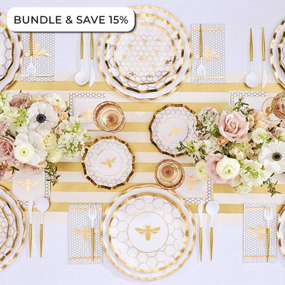 Create an elegant table setting with the Sophistiplate LLC Rosh Tablescape for 16 Guests: White Honeybee, featuring gold bee-themed Rosh Hashanah tableware, a striped table runner, floral arrangements, designer paper plates, coordinating paper napkins, and plastic cutlery. Text in the corner reads BUNDLE & SAVE 15%.