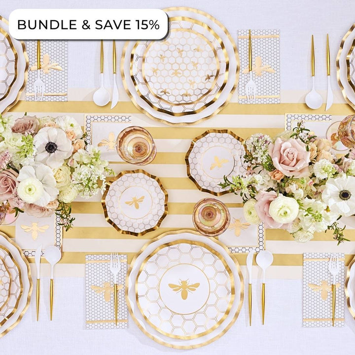 Create an elegant table setting with the Sophistiplate LLC Rosh Tablescape for 16 Guests: White Honeybee, featuring gold bee-themed Rosh Hashanah tableware, a striped table runner, floral arrangements, designer paper plates, coordinating paper napkins, and plastic cutlery. Text in the corner reads BUNDLE & SAVE 15%.