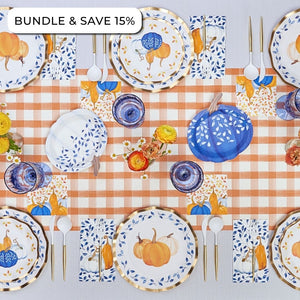 Sophistiplate’s Harvest Blues: Thanksgiving Table for 16 featuring heavy duty paper plates, napkins, and cups decorated with orange and blue pumpkin patterns on a plaid tablecloth, with a Bundle & Save 15% label in the corner.