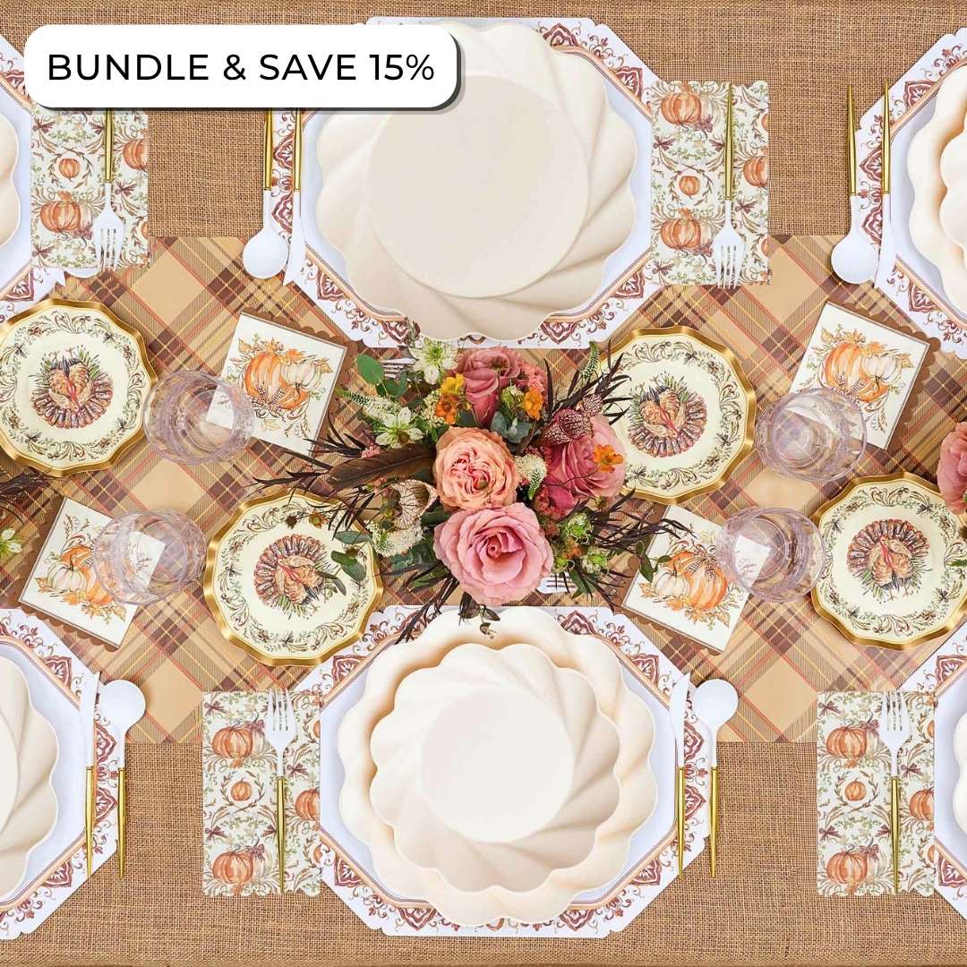 Overhead view of an Ivory Harvest: Thanksgiving Table for 16 set with floral-patterned compostable plates, pumpkin-illustrated napkins, a floral centerpiece, and cutlery, with a tag reading BUNDLE & SAVE 15%.