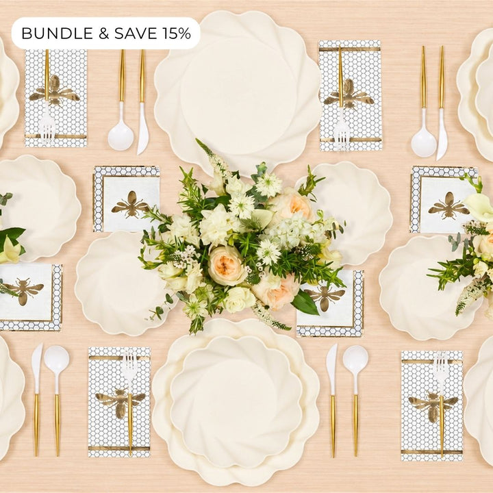 Create a refined tablescape for 16 with the Sophistiplate LLC Rosh Tablescape for 16 Guests: Eco Cream Honeybee set, featuring cream-colored scalloped compostable plates, bee-themed napkins, gold and white cutlery, and floral centerpieces on a light wood surface. Enjoy BUNDLE & SAVE 15% in the top left corner.