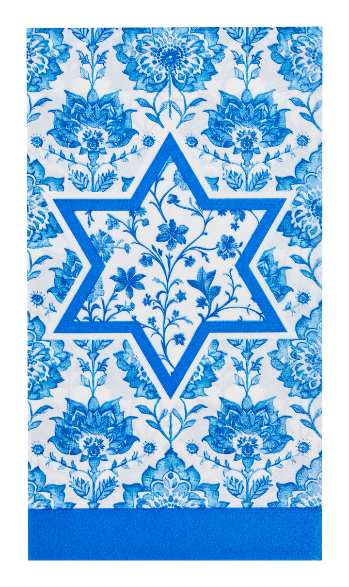 The Hannukah Toile Guest Towels from Sophistiplate (20pk) feature a blue Star of David adorned with floral patterns both inside and around it, set on a white background decorated with repeating blue flowers and finished with a solid blue border at the bottom, making them a festive and elegant addition to your Hanukkah celebrations.