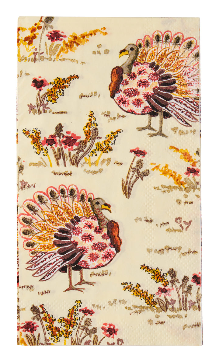 Transform your Thanksgiving table with the Amber Harvest Guest Towels by Sophistiplate, featuring illustrated turkeys with colorful plumage standing among yellow, red, and brown wildflowers on a light background—a festive autumn-themed pattern perfect for holiday napkins.