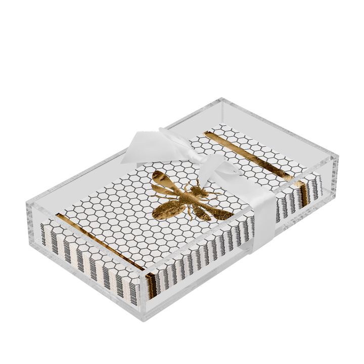 The Sophistiplate Honeybee Guest Towels with Acrylic Tray features a clear rectangular acrylic tray adorned with a white ribbon and includes cards embellished with black stripes, a honeycomb pattern, and a gold bee design—an elegant way to display guest towel napkins in your bathroom.