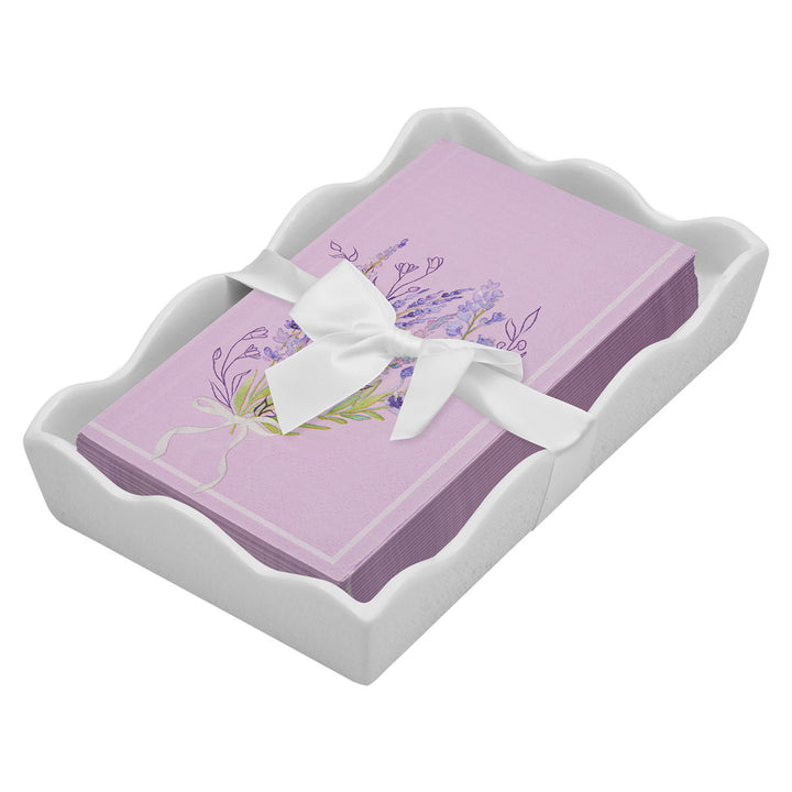The Sophistiplate Floral Guest Towel with Napkin Tray features lavender floral napkins arranged in a ceramic tray, accented with a white ribbon bow.