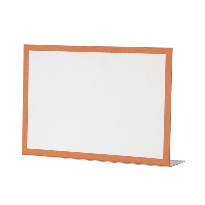 The Hester & Cook Orange Frame Place Card (12ct) is displayed upright on a stand. Featuring a plain white background with an orange border, it's ideal for use as place cards or buffet labels.