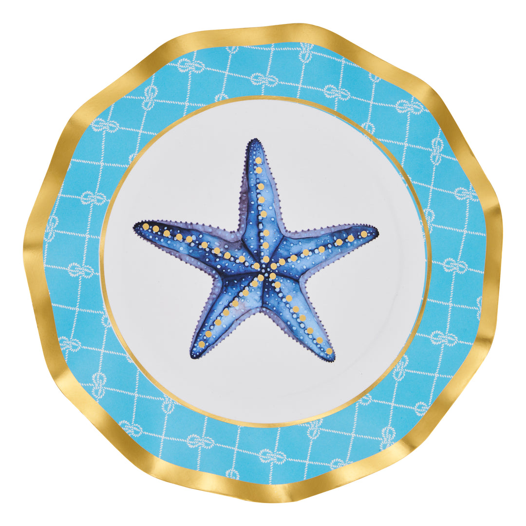 The Sophistiplate Tidal Wave Salad Plates (8pk) feature a wavy edge, blue and yellow starfish center, gold rim, and blue border with white knots—ideal coastal-themed tableware for ocean-inspired parties.