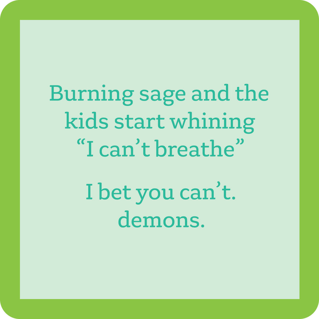 The Burning Sage Coaster by Drinks On Me features a green border, pale blue center, and the funny quote: "Burning sage and the kids start whining I can’t breathe. I bet you can’t. demons." A quirky drink coaster and housewarming gift.