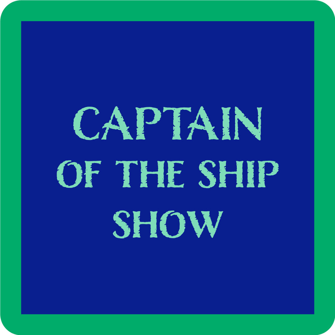 The Captain Coaster by Drinks On Me features a blue square with a green border and bold light blue "CAPTAIN OF THE SHIP SHOW" text—perfect as a funny drink coaster or playful bar cart accessory.