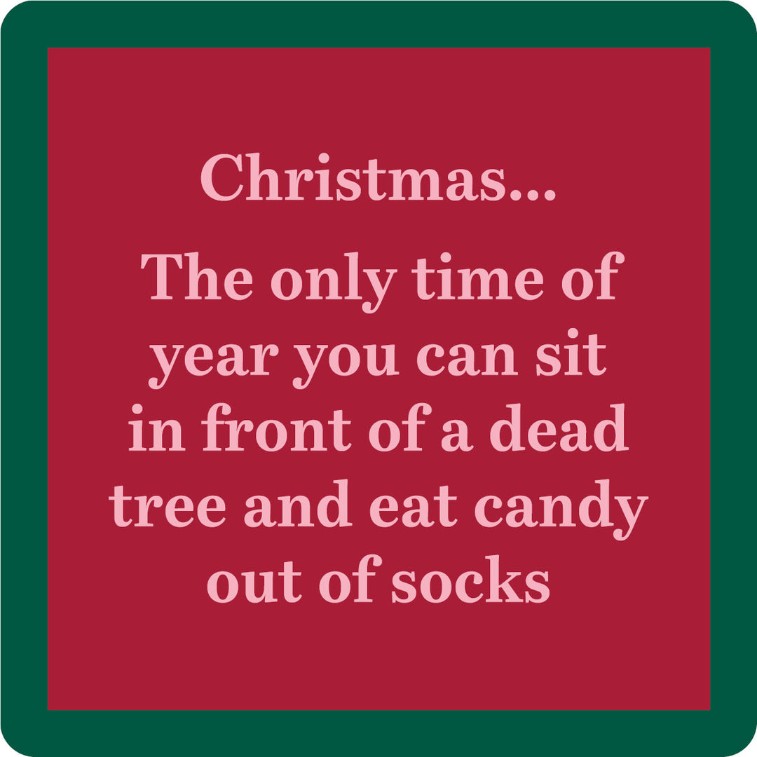 The Xmas Dead Tree Coaster by Drinks On Me features a red square design with a green border and white text: "Christmas... The only time of year you can sit in front of a dead tree and eat candy out of socks." A funny, festive coaster or hostess gift.