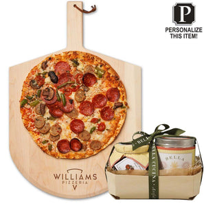 The Maple Personalized Pizza Peel Gift Set features a pizza on a custom board labeled Williams Pizzeria, alongside a ribboned gift basket with candle and more. A “Personalize This Item!” sign is shown in the top right corner.