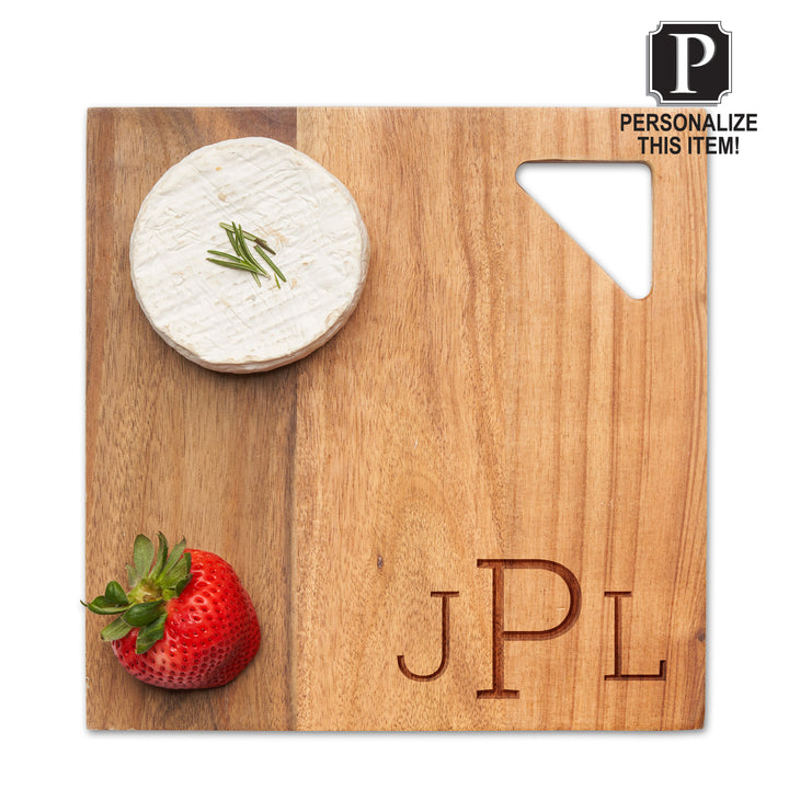 The 9" Maple Acacia Modern Geo Square board, personalized with JPL, holds herbed cheese and a strawberry. Ideal for charcuterie, it features a unique triangular cut-out in the top right corner.